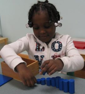 Montessori Student with size puzzle